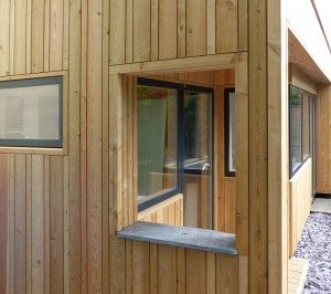 Siberian larch cladding used vertically in random widths.